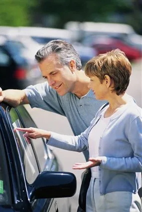 A couple looking at a car