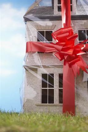 A house wrapped with a red ribbon